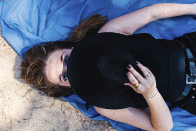 High angle view of woman lying on bed