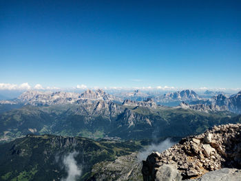 Scenic view of mountains against clear blue sky