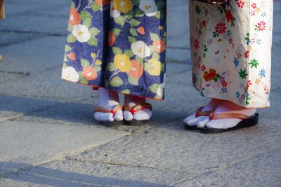 Low section of women standing on street