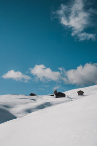 Scenic view of snowcapped landscape against blue sky