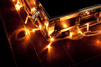 High angle view of fairy lights around box on table