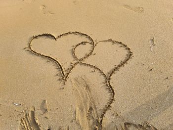 High angle view of heart shape on sand