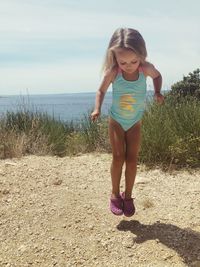 Full length of girl standing on beach