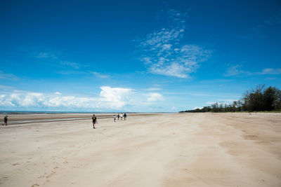 Scenic view of beach against blue sky