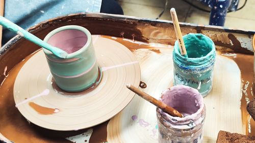 Cropped hand of person working on pottery wheel