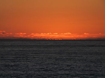 Scenic view of sea against orange sky