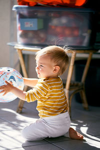 Cute boy playing with toy at home