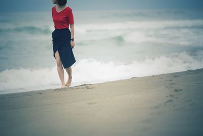 Full length of woman walking on beach