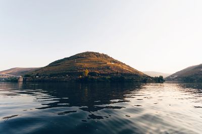 Scenic view of lake and mountains against clear sky