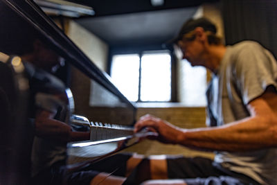 A man plays the grand piano