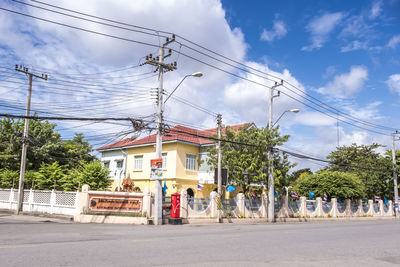 Group of people walking on road against buildings