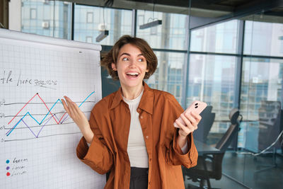 Portrait of young woman using mobile phone