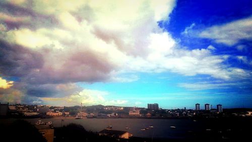 Cityscape against cloudy sky