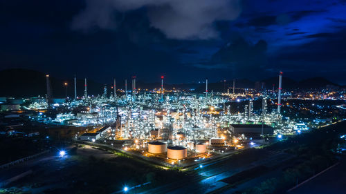 High angle view of illuminated cityscape against sky at night