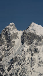 Scenic view of snowcapped mountains against clear blue sky