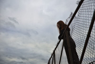 Low angle view of monkey against sky