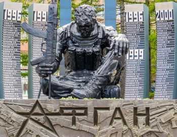 Statue against buildings in city