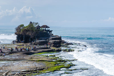 People on beach against sky