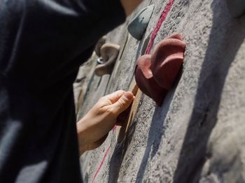 Cropped image of hand on climbing wall