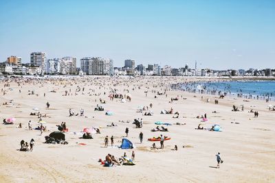 Group of people on beach against sky