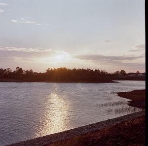 Scenic view of lake against sky during sunset