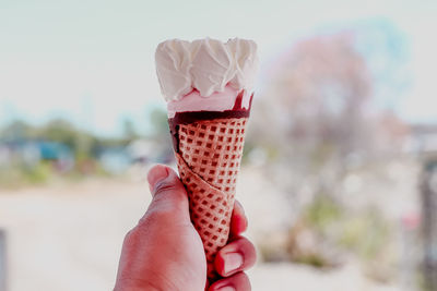 Close-up of hand holding ice cream