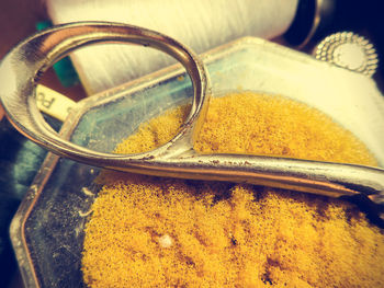 High angle view of yellow container on table