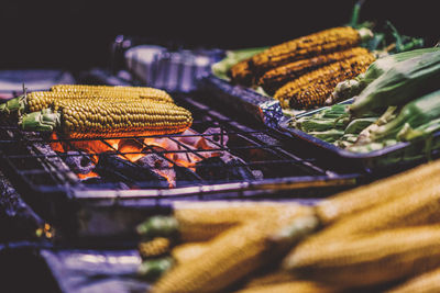 Close-up of corns being cooked on barbecue grill