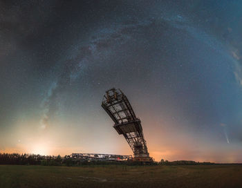 Low angle view of illuminated tower against sky at night