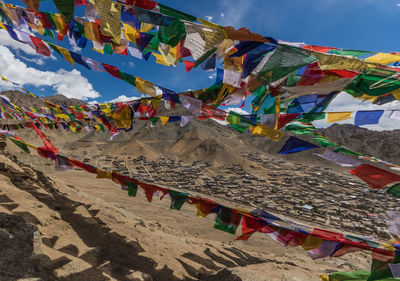 Low angle view of flags hanging against sky