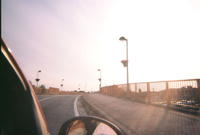 Street against clear sky seen through car windshield