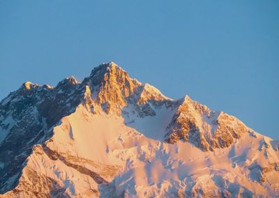 Scenic view of snowcapped mountains against clear blue sky