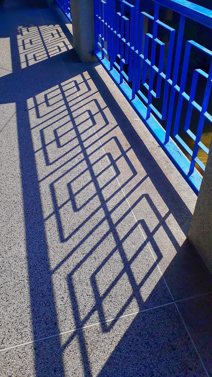 HIGH ANGLE VIEW OF TEXT ON FOOTPATH WITH SHADOW