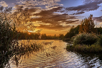 Scenic view of lake against sky during sunset