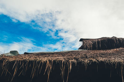 Low angle view of hut on land against sky