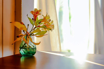 Flower vase on table at home