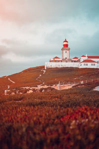 Low angle view of lighthouse on mountain against sky