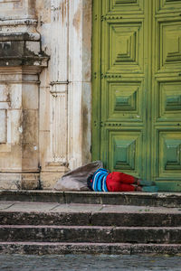 Homeless lying down on church steps