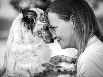 Close-up of young woman with dog