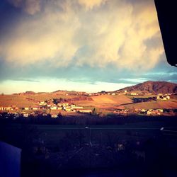 Townscape against sky during sunset