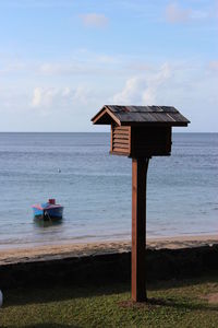 Lifeguard hut on beach against sky