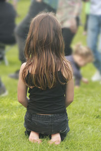 Rear view of woman on field