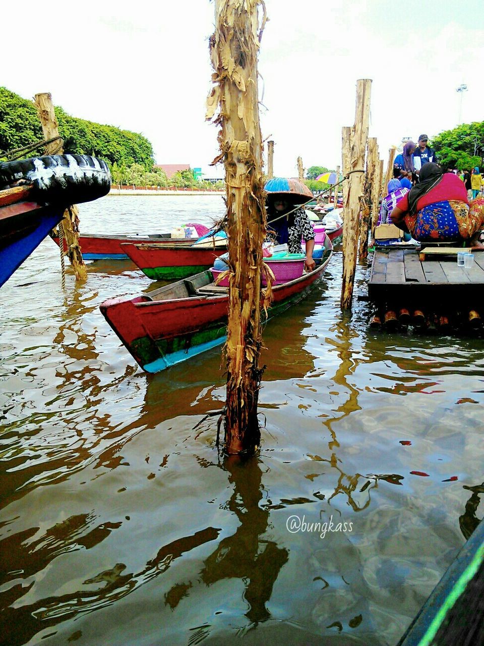 water, reflection, nautical vessel, moored, boat, lake, waterfront, sky, day, tranquility, nature, tree, built structure, standing water, outdoors, mode of transport, transportation, architecture, clear sky, wood - material