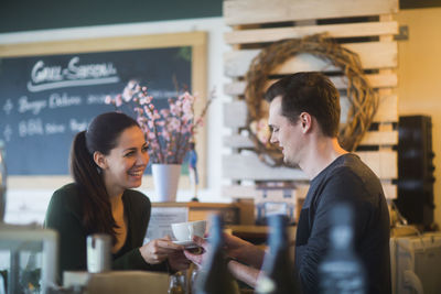 Young couple in a restaurant in love drinking coffee