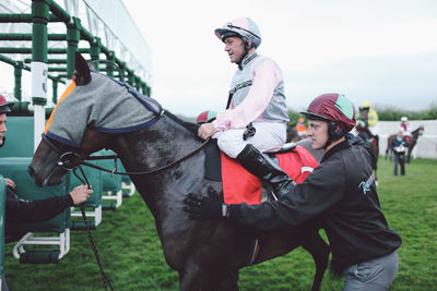 Close-up of young man holding horse