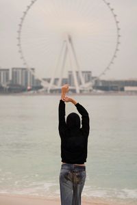 Rear view of woman standing in sea