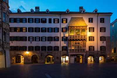 Illuminated building against sky at dusk