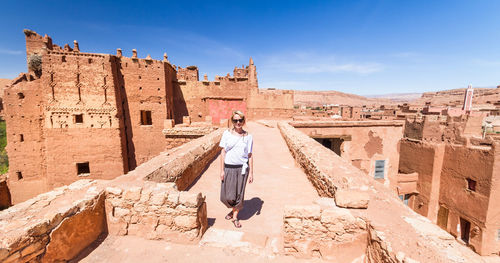 Full length of man standing on historical building