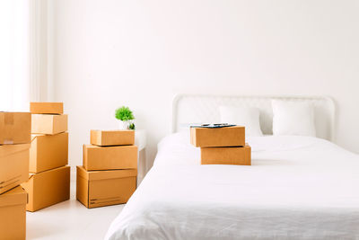 Cardboard boxes on bed at home