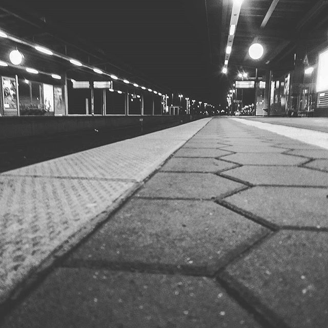 the way forward, illuminated, diminishing perspective, transportation, vanishing point, built structure, architecture, empty, indoors, surface level, in a row, lighting equipment, railroad station platform, public transportation, night, ceiling, long, absence, incidental people, rail transportation